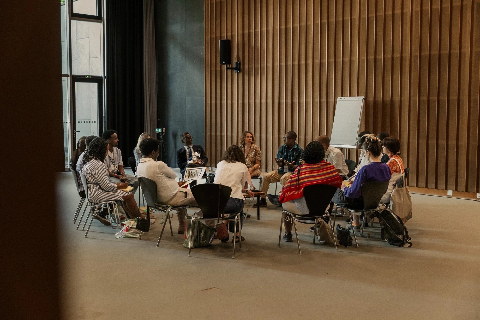 group sitting in a circle during a workshop at HKW
